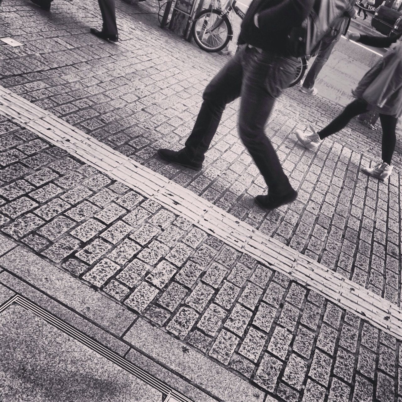 high angle view, lifestyles, low section, leisure activity, men, person, unrecognizable person, shadow, sunlight, street, pattern, tiled floor, part of, day, walking, cobblestone