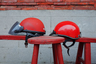 Red fire hydrant against brick wall