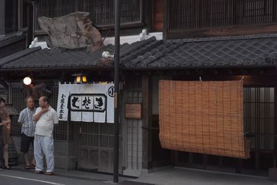 Man standing outside house