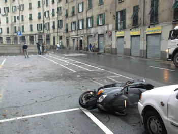 Vehicles on road by buildings in city