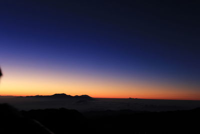 Scenic view of silhouette landscape against clear sky during sunset