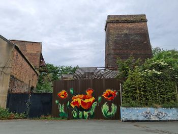 Plants and old building against sky
