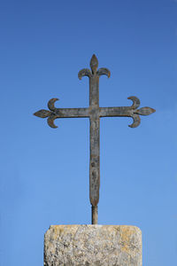 Low angle view of cross against clear blue sky