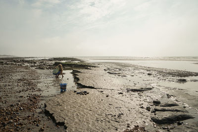 Man standing on beach against sky