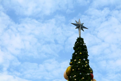 Low angle view of christmas tree against sky