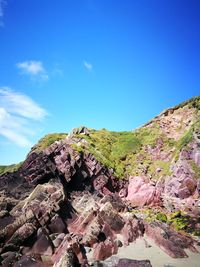 Scenic view of mountain against blue sky