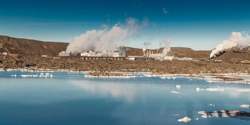 Panoramic view of lake against blue sky