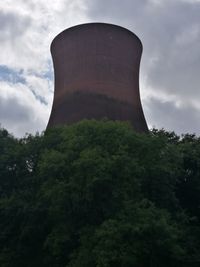 Low angle view of smoke stack against sky