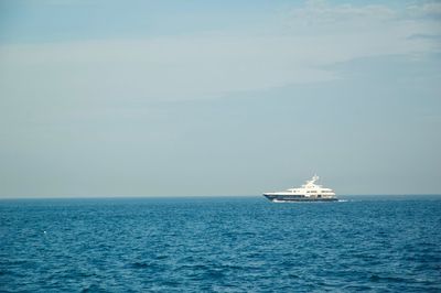 Sailboat sailing on sea against sky