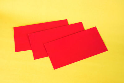 High angle view of arrow symbol on yellow paper