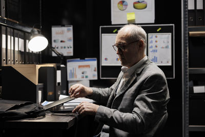 Side view of young man working at office