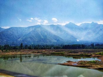 Scenic view of lake and mountains against sky