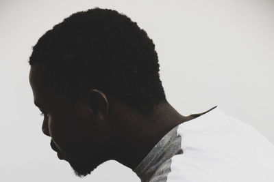 Portrait of young man against white background