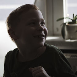 Close-up of smiling boy at home