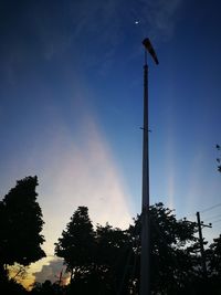 Low angle view of street lights against sky during sunset