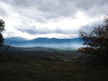 Scenic view of mountains against cloudy sky