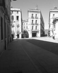 Street amidst buildings in city against sky