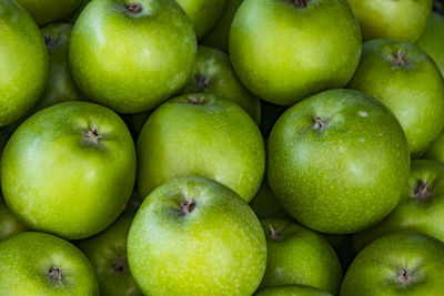 Close up green apples on market stand