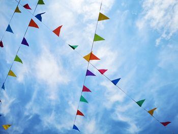 Low angle view of flags against sky