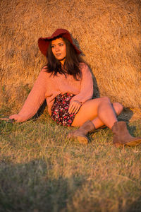 Young woman sitting on field