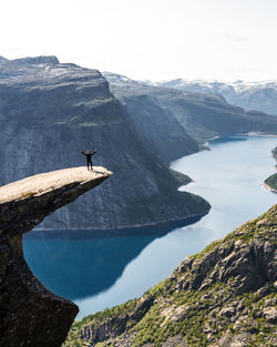 Scenic view of sea and mountains against sky