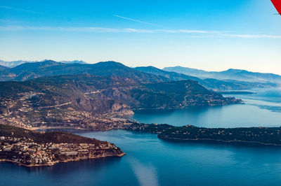 Aerial view of sea and mountains against sky