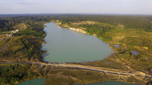 High angle view of lake amidst trees against sky