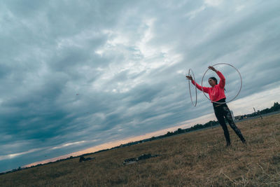 Full length of person standing on field against sky