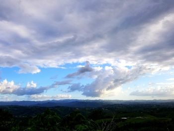 Scenic view of landscape against dramatic sky