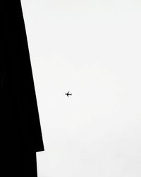 Low angle view of airplane flying in sky