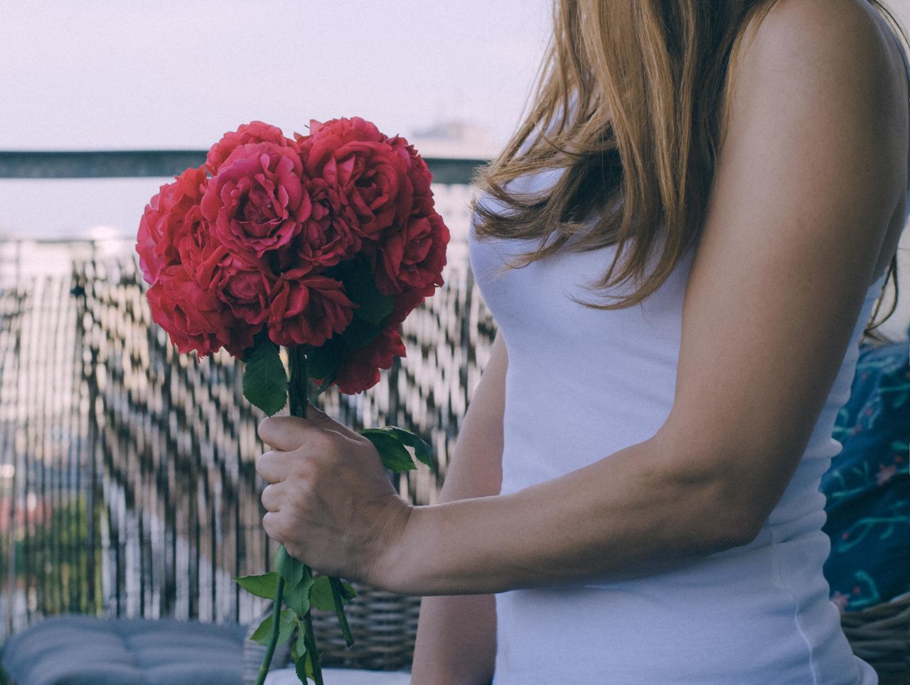 flower, flowering plant, beauty in nature, one person, plant, real people, nature, rose - flower, women, freshness, rose, vulnerability, midsection, lifestyles, fragility, holding, adult, leisure activity, flower arrangement, bouquet, flower head, hairstyle, outdoors