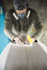 Surfboard shaper refining a new design