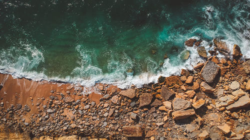 Scenic view of sea waves splashing on rocks