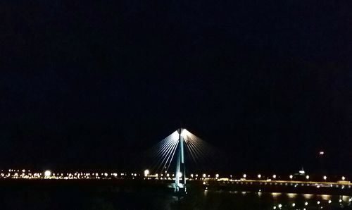 Low angle view of illuminated city against sky at night