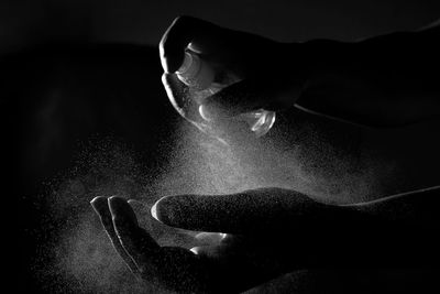 Close-up of hand holding black background