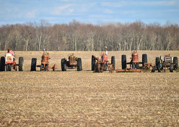 Group of people on field against sky