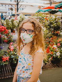 Close-up of cute girl standing in flower shop