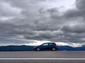 View of mountain road against cloudy sky