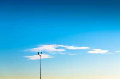 Low angle view of lamp post against blue sky