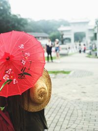 Close-up of woman with umbrella on street