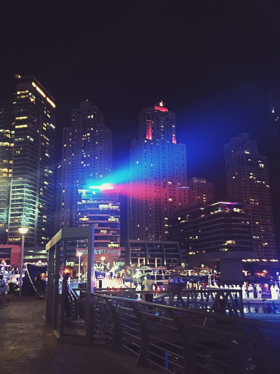 illuminated, city, urban skyline, building exterior, skyscraper, night, cityscape, architecture, built structure, travel destinations, outdoors, multi colored, sky, neon, no people, nightlife