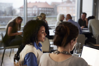 Women talking in cafeteria