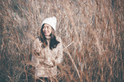 Young woman standing in field