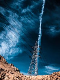 Low angle view of electricity pylon against sky