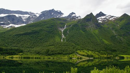 Scenic view of landscape and mountains against sky