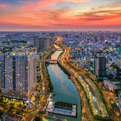 High angle view of illuminated buildings against sky during sunset