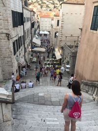 People walking on street amidst buildings in city