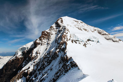 Scenic view of snow covered mountains against sky