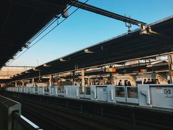 Train at railroad station against clear sky