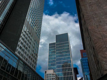 Low angle view of modern buildings in city against sky